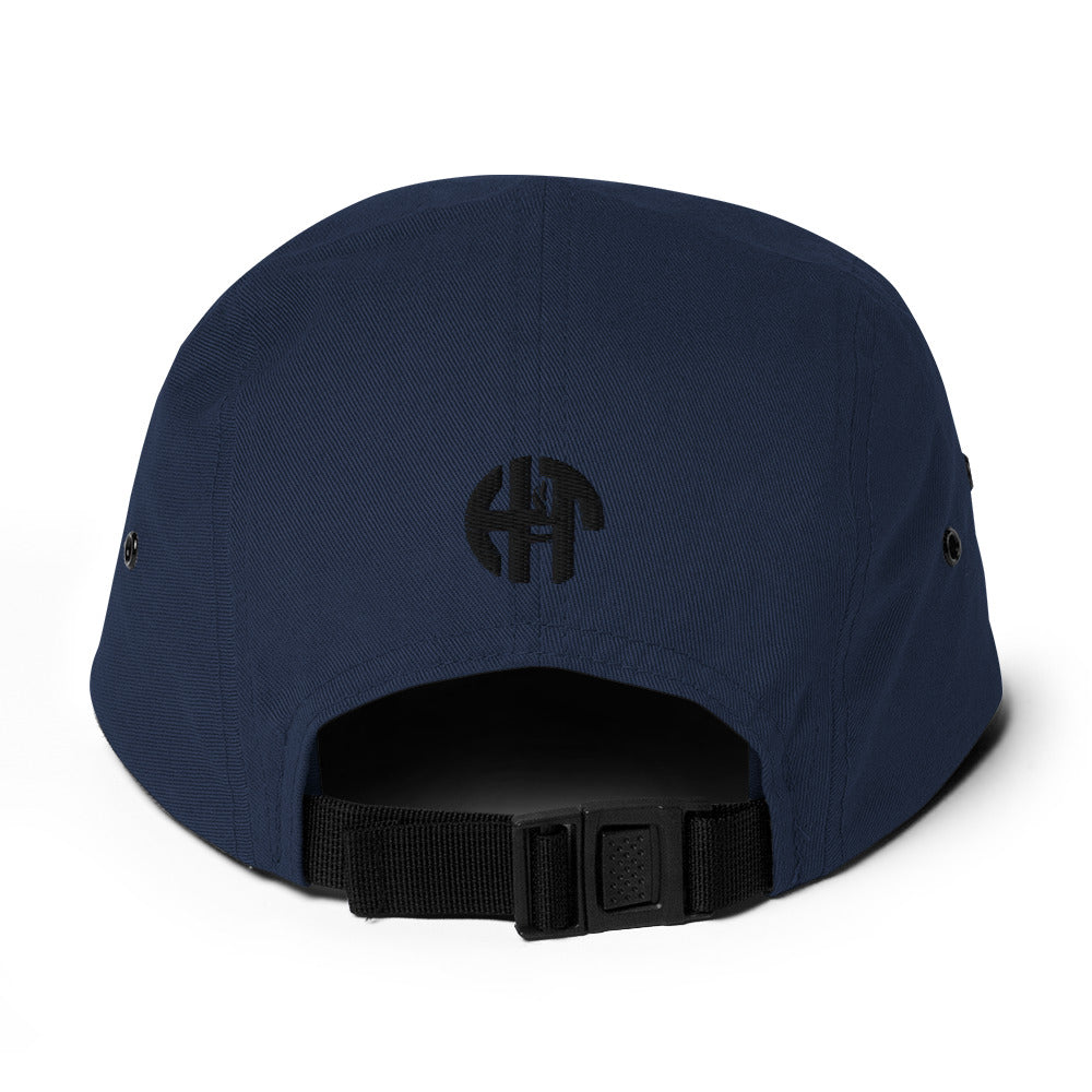 Classic HFT five-panel cap featuring a low profile fit, a nylon strap clip closure at the back with an adjustable strap, and a subtle HFT logo on the rear, set against a plain backdrop for a clean presentation navy black