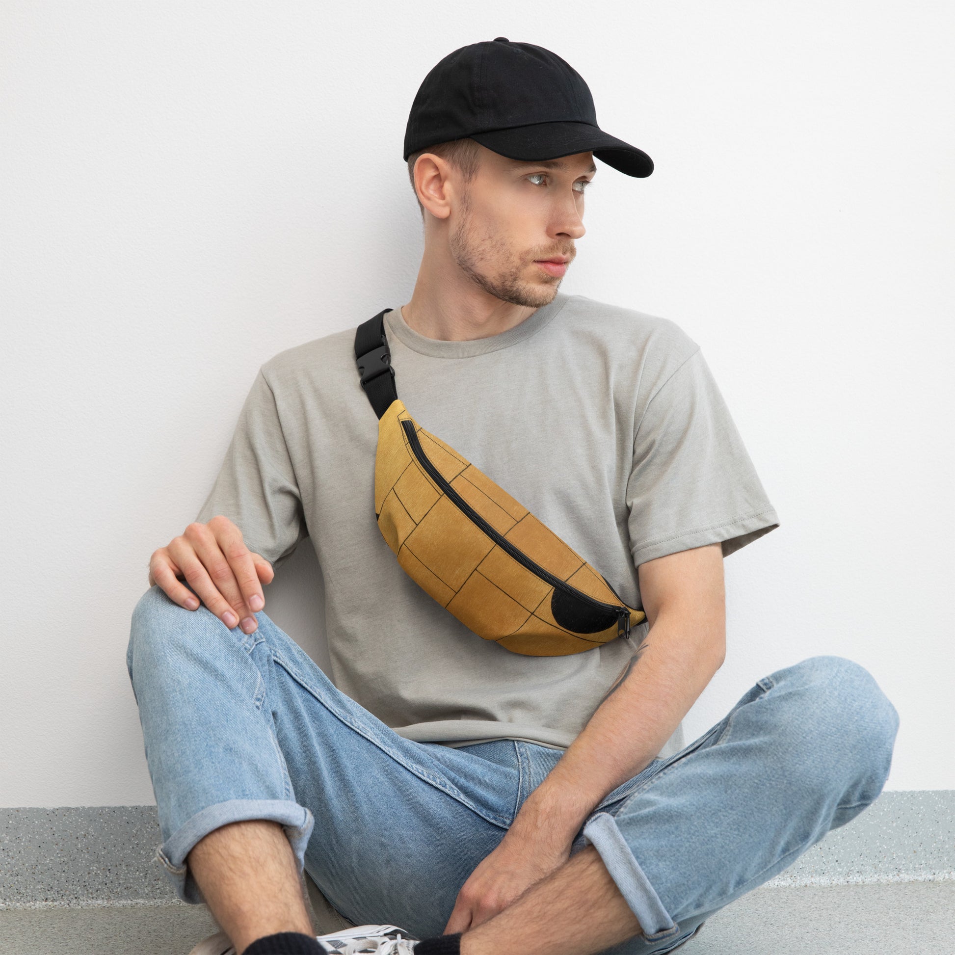 Stylish HFT Fanny Pack III in camel brown with a black abstract design, featuring a large zippered compartment and a durable, adjustable black strap, against a clear background male sitting