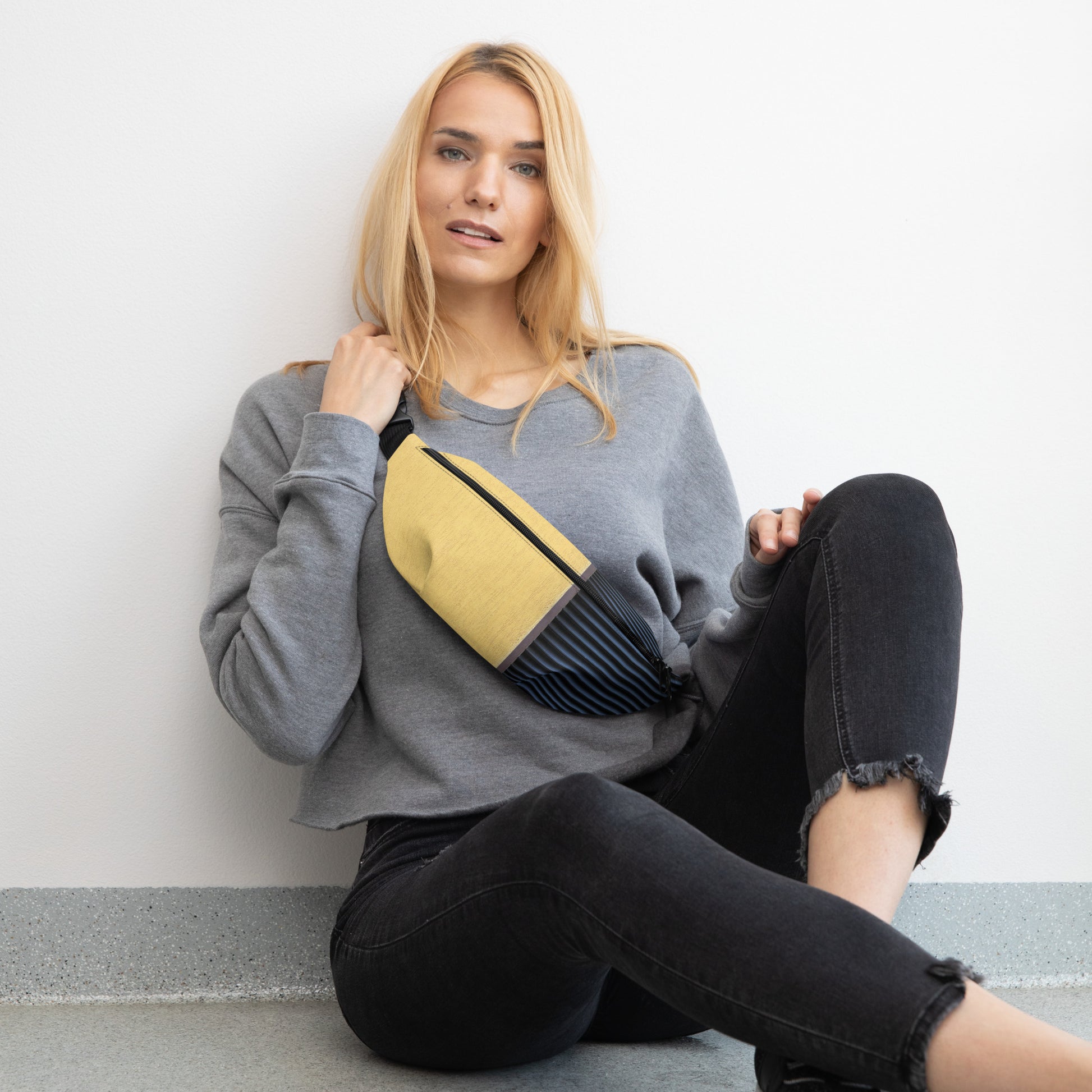 Stylish HFT Fanny Pack V with adjustable straps featuring a mustard-yellow canvas front, navy-blue pleated detail, and the HFT logo on the back 