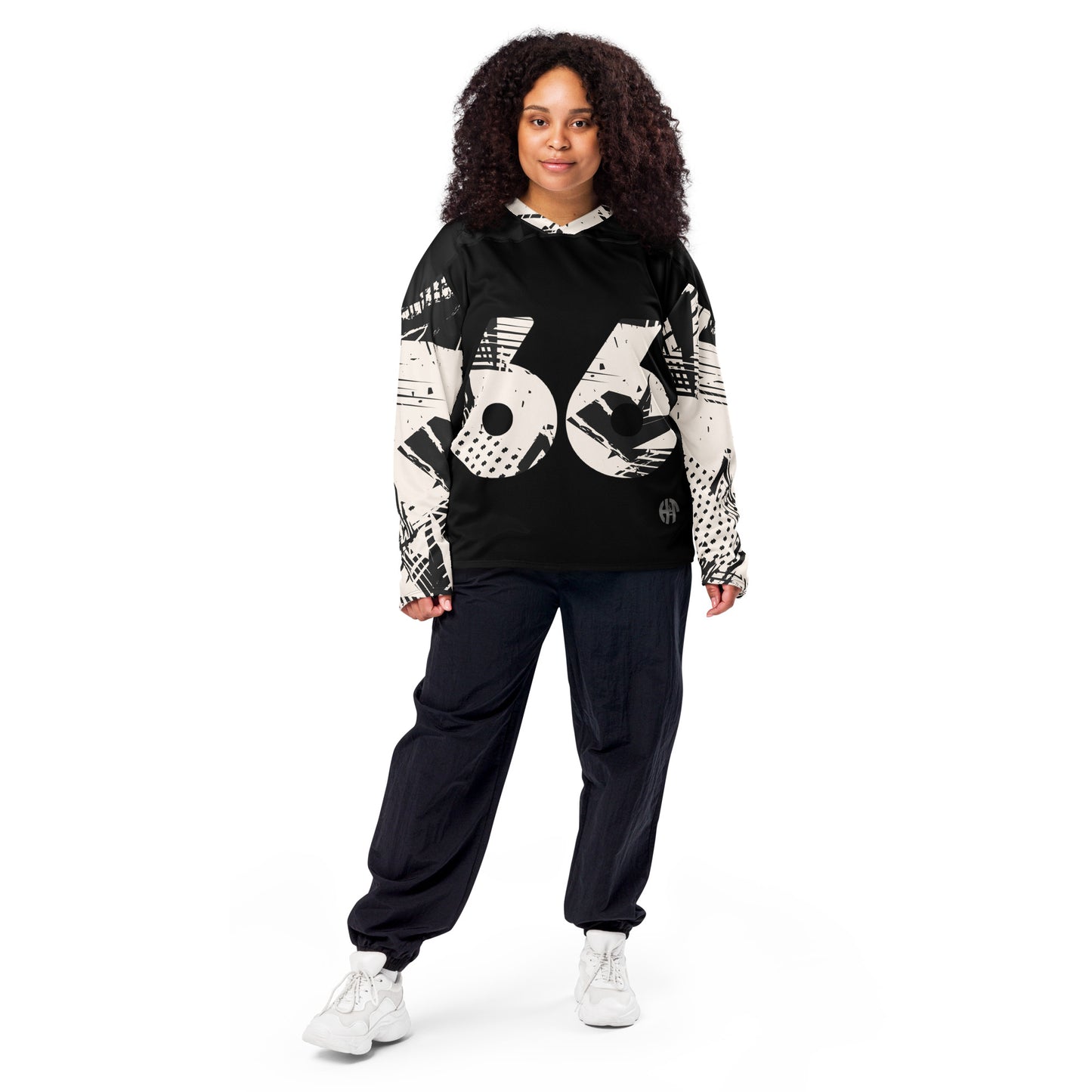 A stylized black hockey jersey with a bold, graphic design featuring the number 66 in large, white, distressed font prominently displayed on the front. The sleeves and shoulders are adorned with abstract black and white patterns, adding a modern touch to the athletic wear female