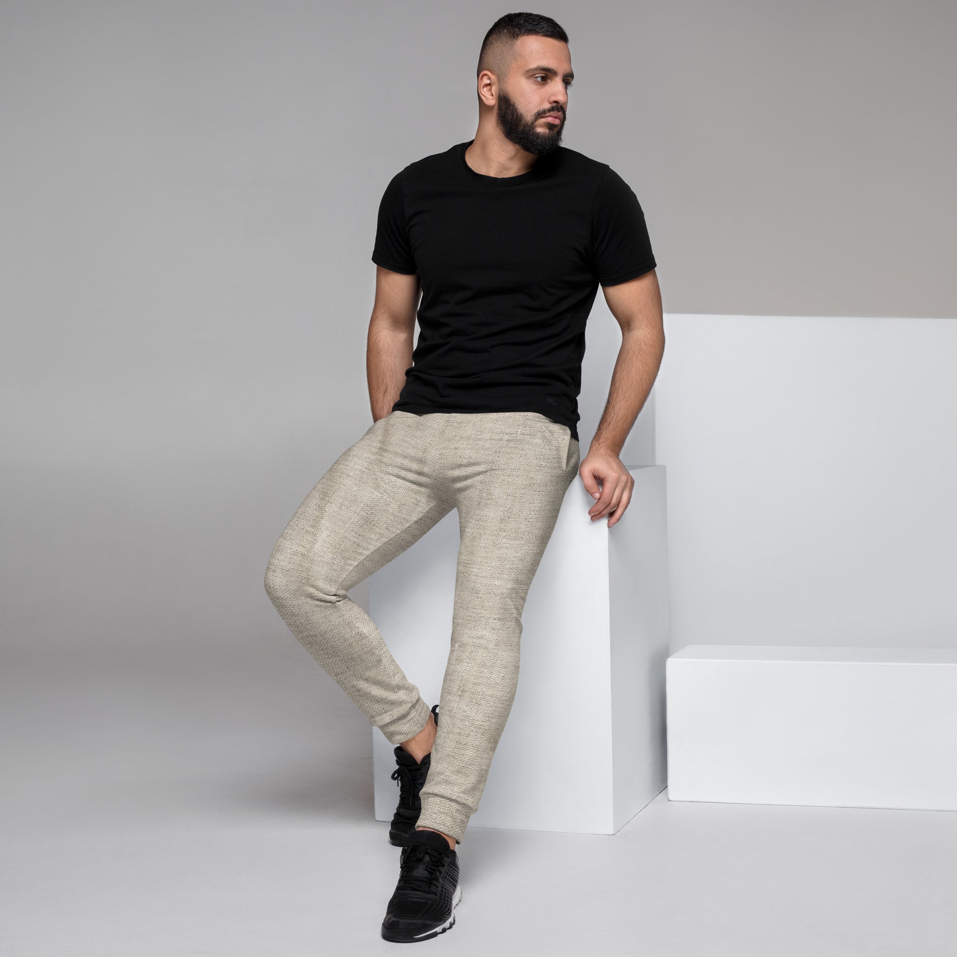 Beige HFT Men's Joggers on a white background, showcasing their soft texture and comfortable fit, perfect for workouts or lounging left view