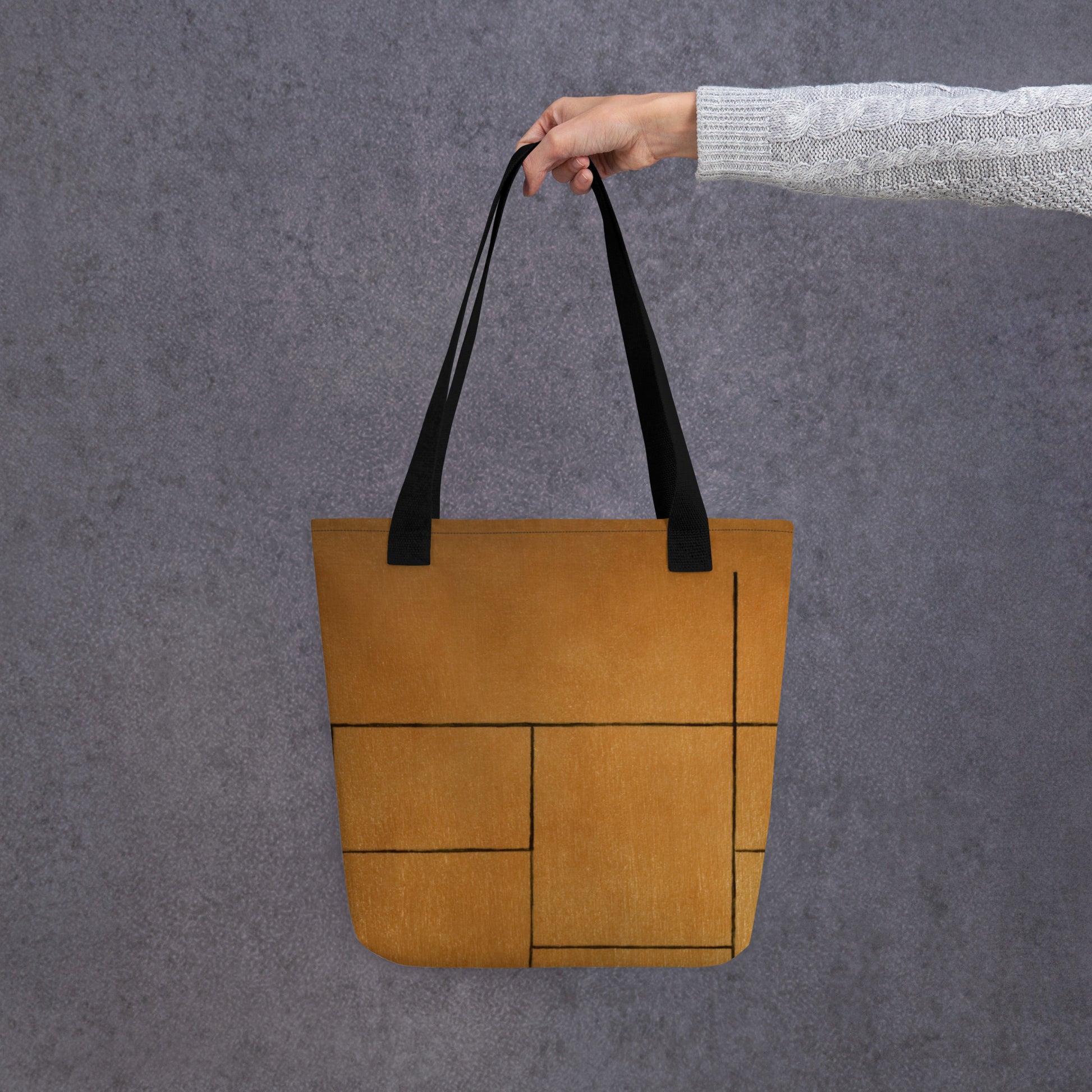 person hold HFT Tote Bag I in a stylish camel brown color with black handles, shows off its spacious design and external pocket detail