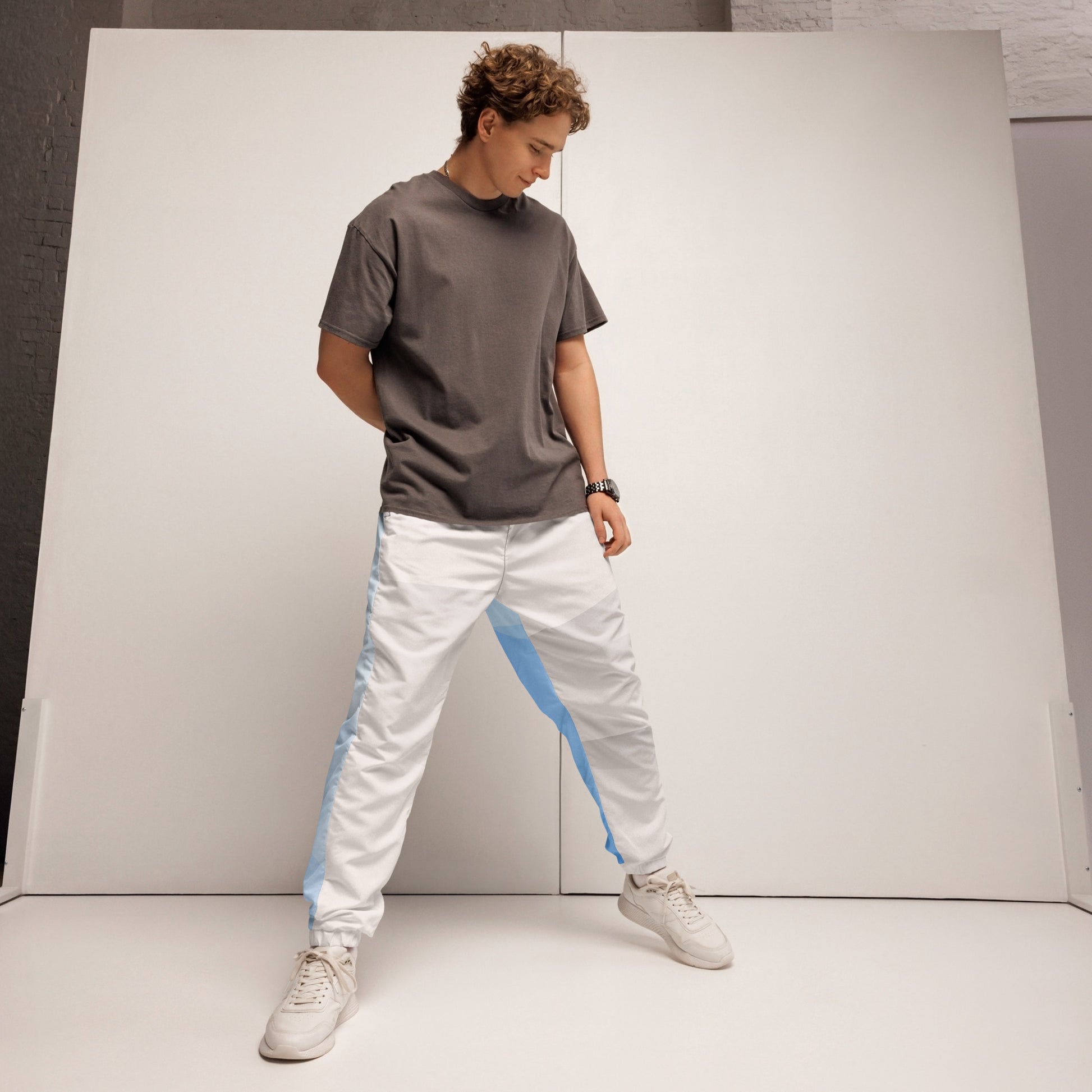 legant HFT Unisex Track Pants III in a color-block design with white and light blue panels, featuring water-resistant fabric, mesh lining, and elastic ankle cuffs front