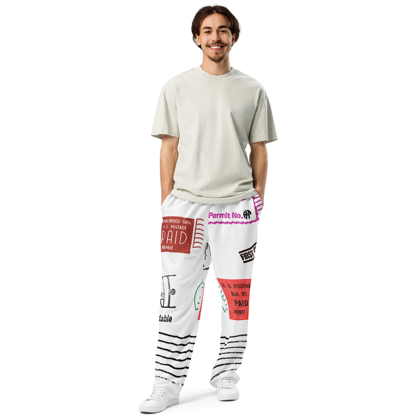 Trendy unisex HFT wide-leg joggers with an all-over postal print design, featuring a mix of U.S. postage paid stamps and permit labels, in a black, red, and blue color scheme on a white background front