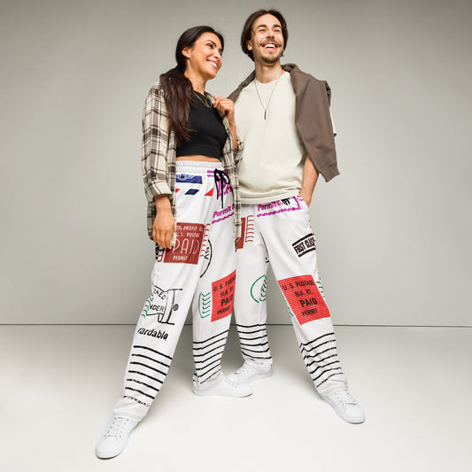 Trendy unisex HFT wide-leg joggers with an all-over postal print design, featuring a mix of U.S. postage paid stamps and permit labels, in a black, red, and blue color scheme on a white background two models