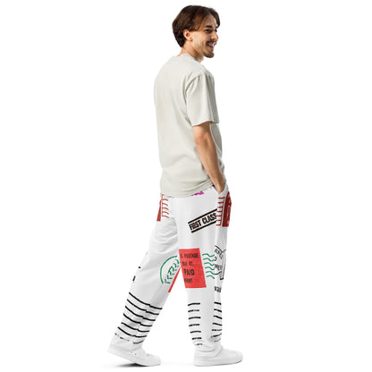 Trendy unisex HFT wide-leg joggers with an all-over postal print design, featuring a mix of U.S. postage paid stamps and permit labels, in a black, red, and blue color scheme on a white background male back