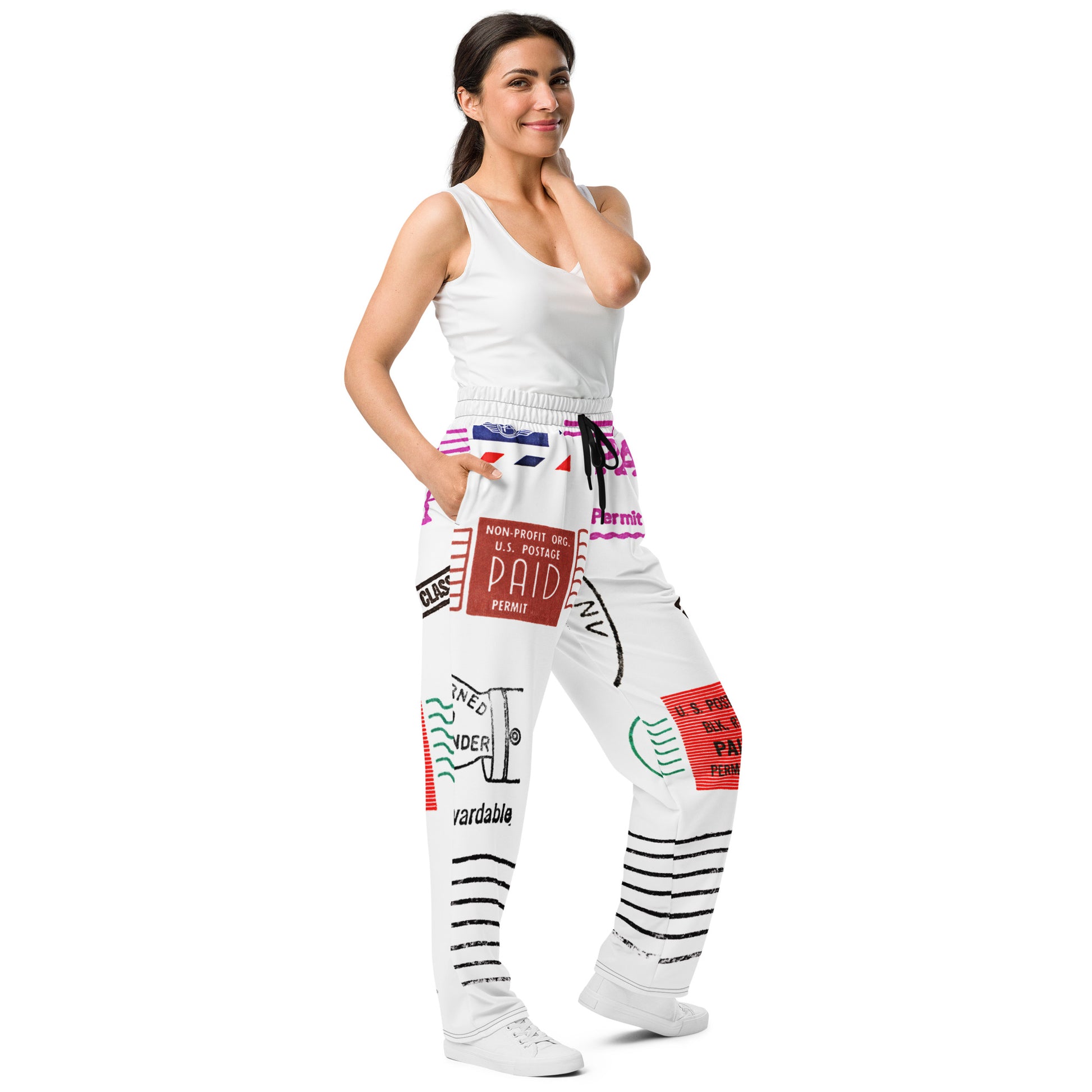 Trendy unisex HFT wide-leg joggers with an all-over postal print design, featuring a mix of U.S. postage paid stamps and permit labels, in a black, red, and blue color scheme on a white background female front