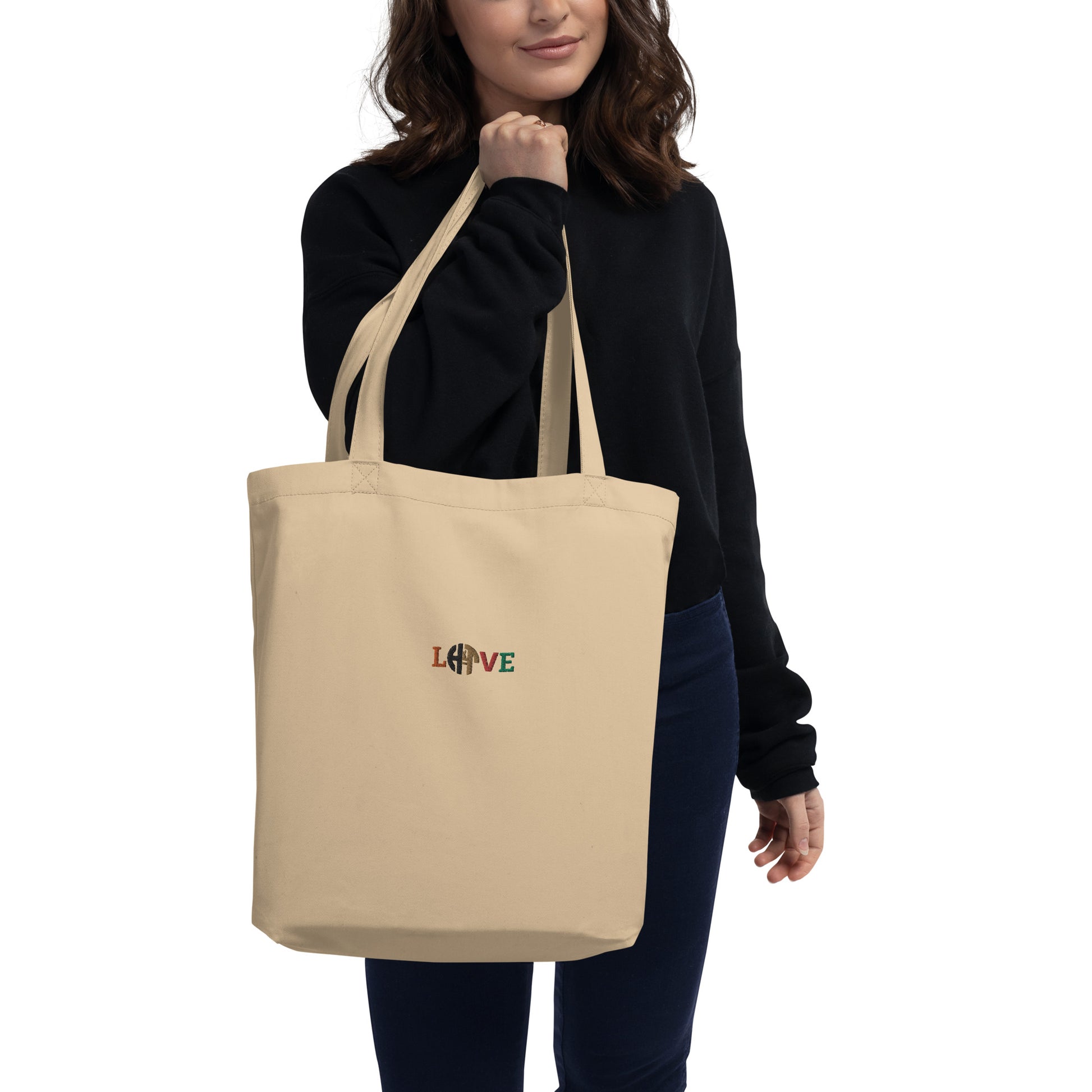 Eco-friendly unisex beige organic cotton tote bag with HFT logo styled as 'LOVE' printed on the front, showcasing ample space, perfect for carrying groceries or books