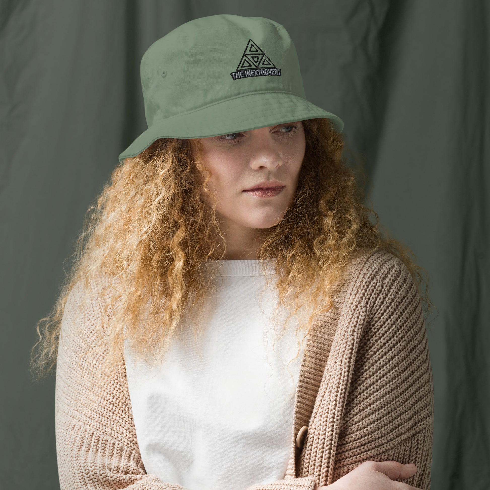 The Inextrovert Organic Bucket Hat made of 100% cotton twill with a boldtriangle logo, showcasing a minimalist and breathable design, casting a soft shadow on a bright surface dill front