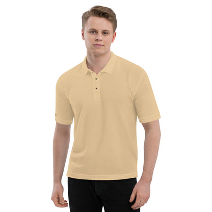 Port Authority Men's Premium Polo shirt in a relaxed fit, featuring a flat knit collar, metal buttons, and HFT store embroidery. Shown in a classic stone front male model smile