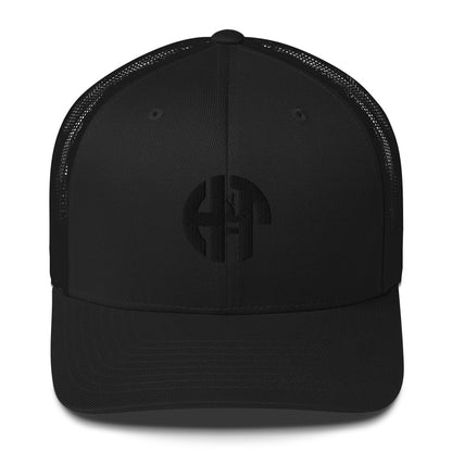 A stylish six-panel trucker cap with a breathable mesh back and a front panel featuring a black 'HFT' logo, complete with a pre-curved brim and an adjustable snap closure for comfort black front