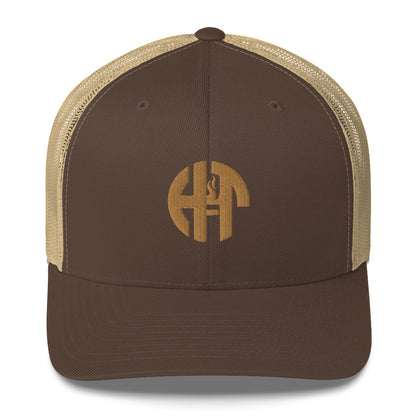 A stylish six-panel trucker cap with a breathable mesh back and a front panel featuring a black 'HFT' logo, complete with a pre-curved brim and an adjustable snap closure for comfort khaki front