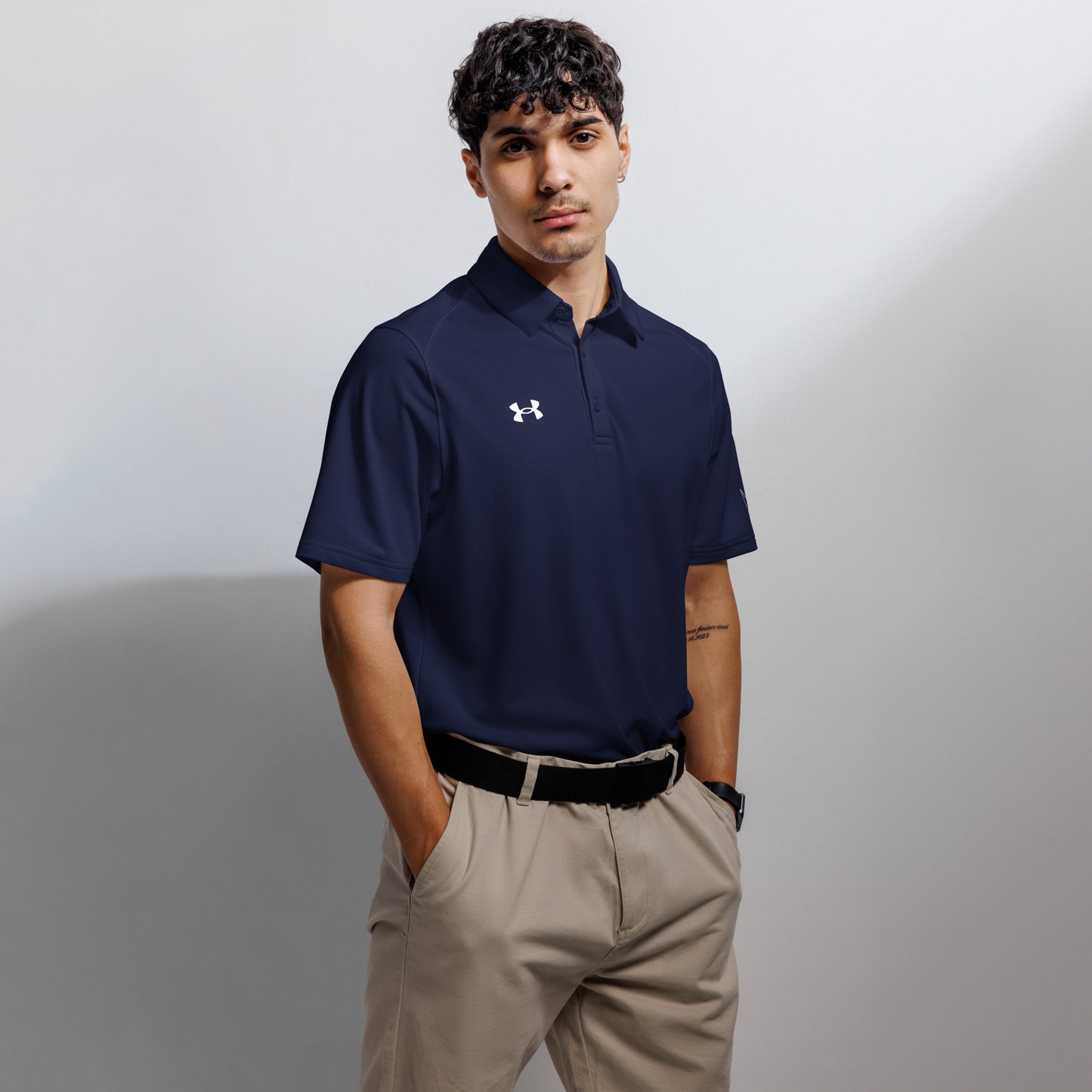 Under Armour men's navy blue polo shirt with moisture-wicking fabric and anti-odor technology, suitable for sports and casual wear.