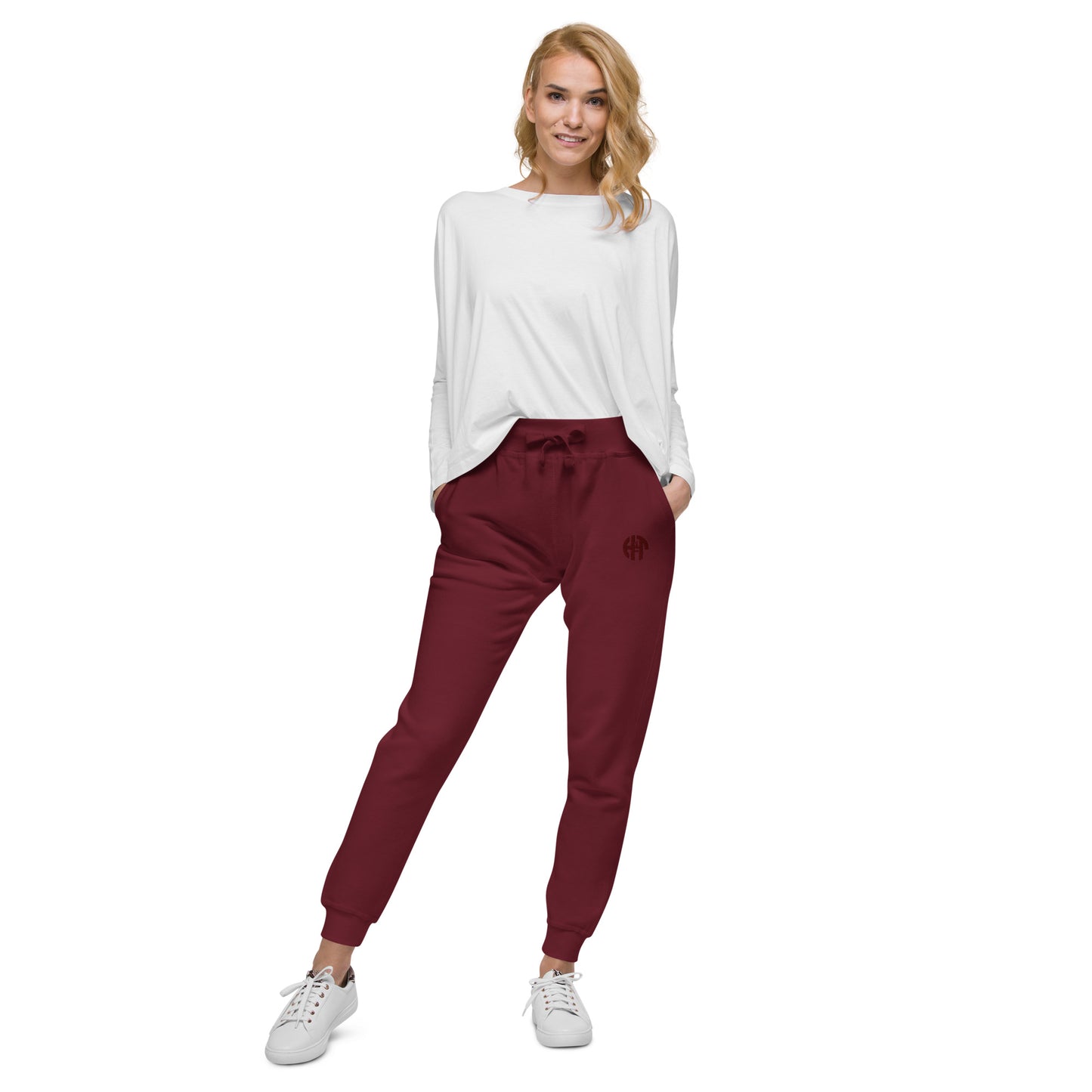 unisex fleece sweatpants with a comfortable fit, featuring an elastic waistband, elastic ankle cuffs, and a subtle black 'HFT' logo on the upper left thigh maroon female