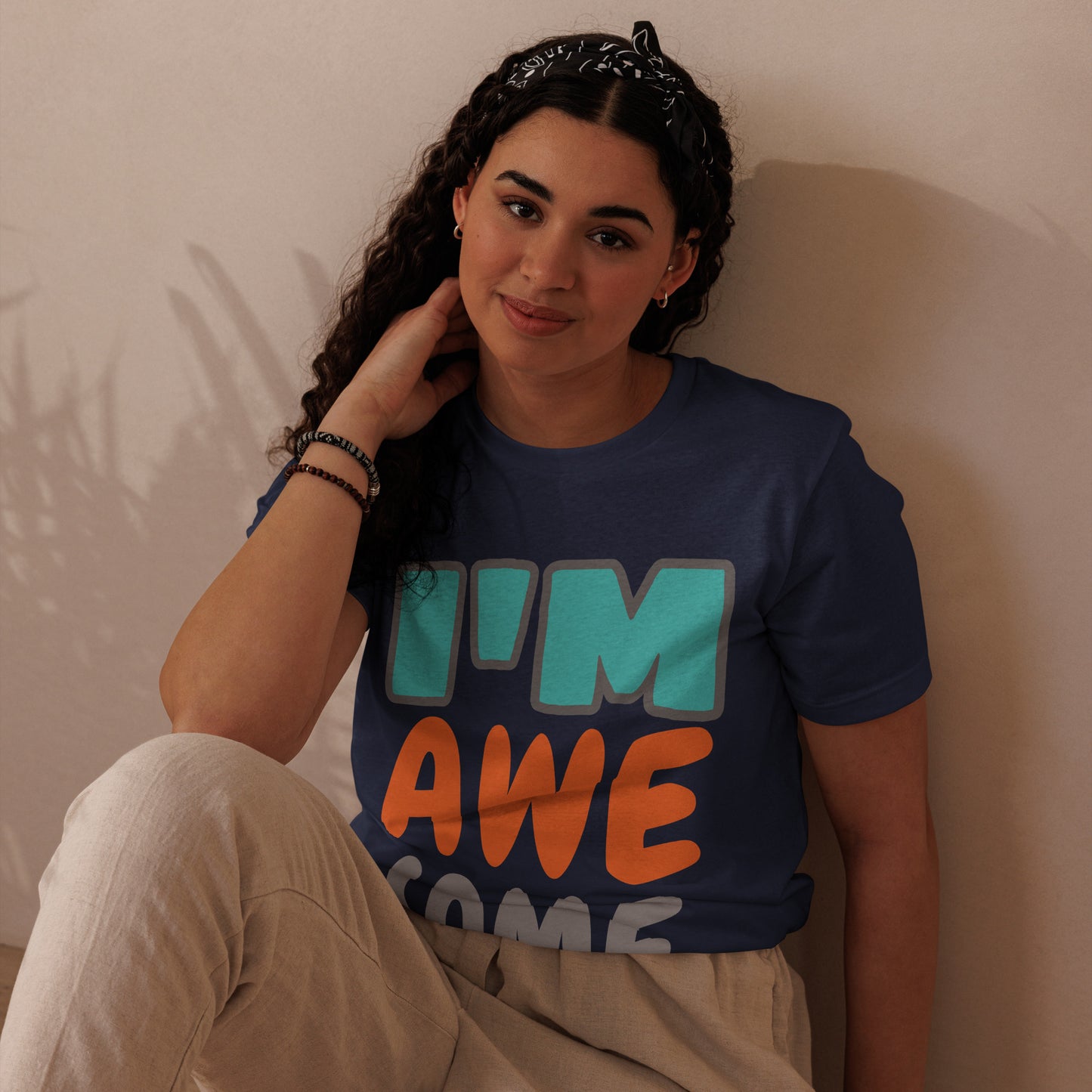 woman wearing HFT Unisex Staple Eco T-shirts, with the navy tee featuring the text 'I'm awesome' in multicolor woman