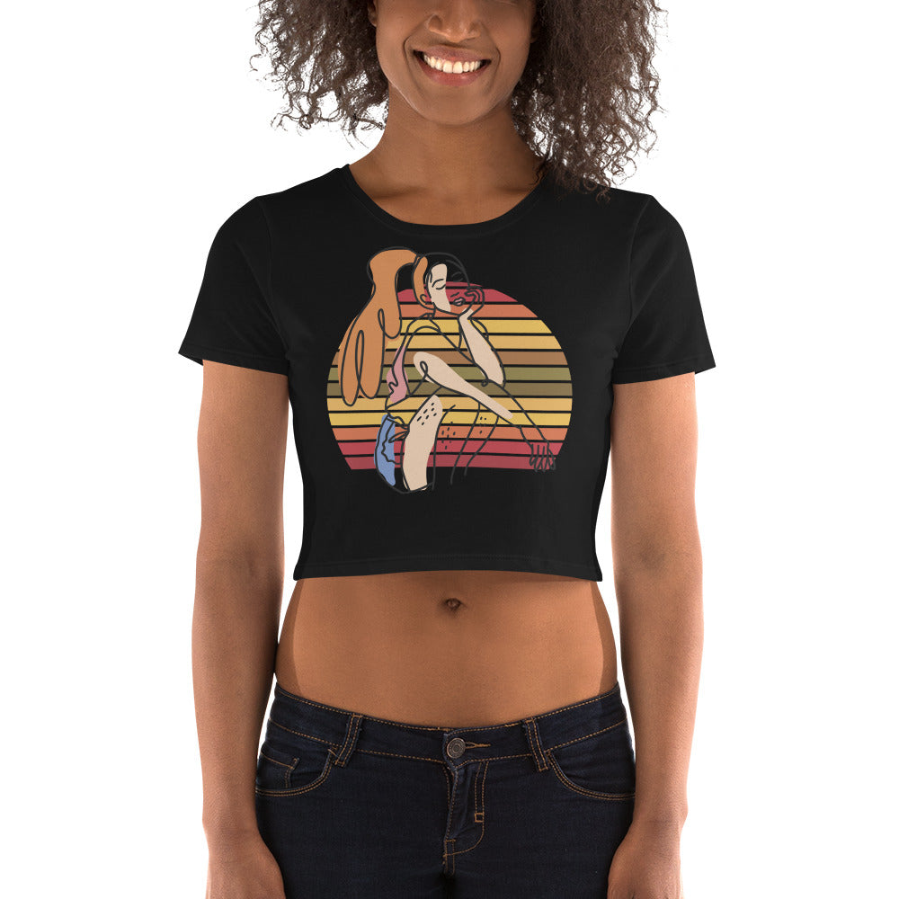 Black HFT Women's Crop Tee with a colorful, retro-inspired graphic print of a woman seated and wearing headphones, model  no show face