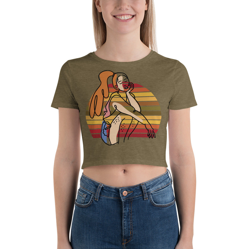  Heather Olive HFT Women's Crop Tee with a colorful, retro-inspired graphic print of a woman seated and wearing headphones, model no face show