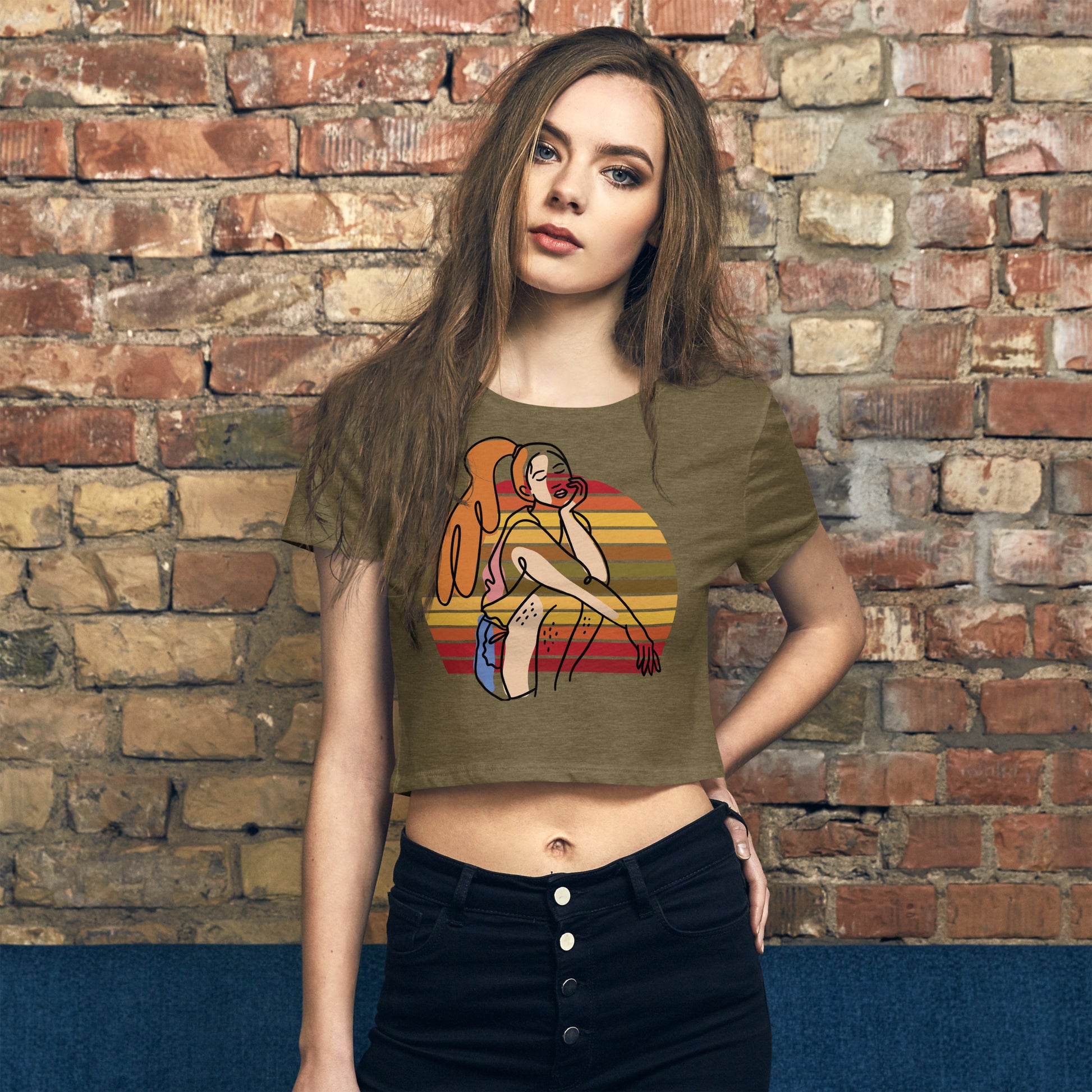  Heather Olive HFT Women's Crop Tee with a colorful, retro-inspired graphic print of a woman seated and wearing headphones, model front