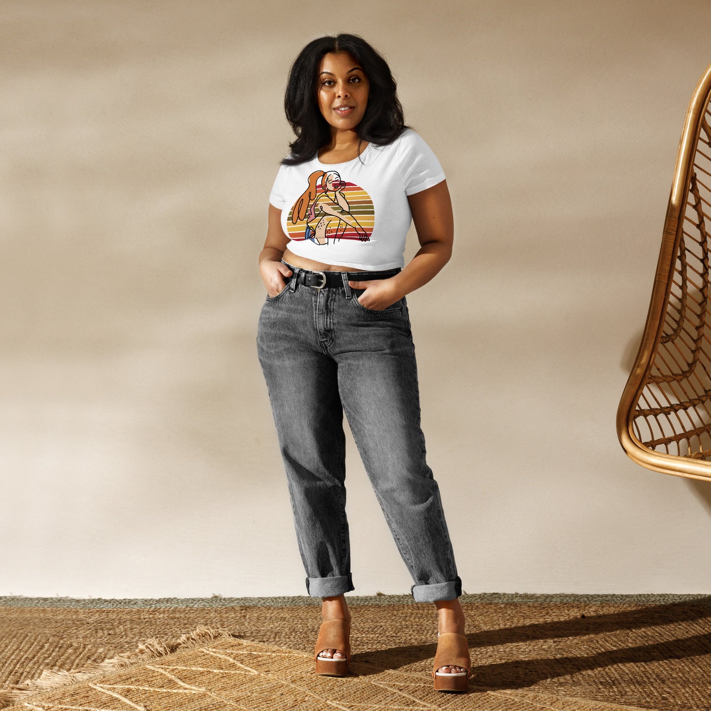 White HFT Women's Crop Tee with a colorful, retro-inspired graphic print of a woman seated and wearing headphones, model wear