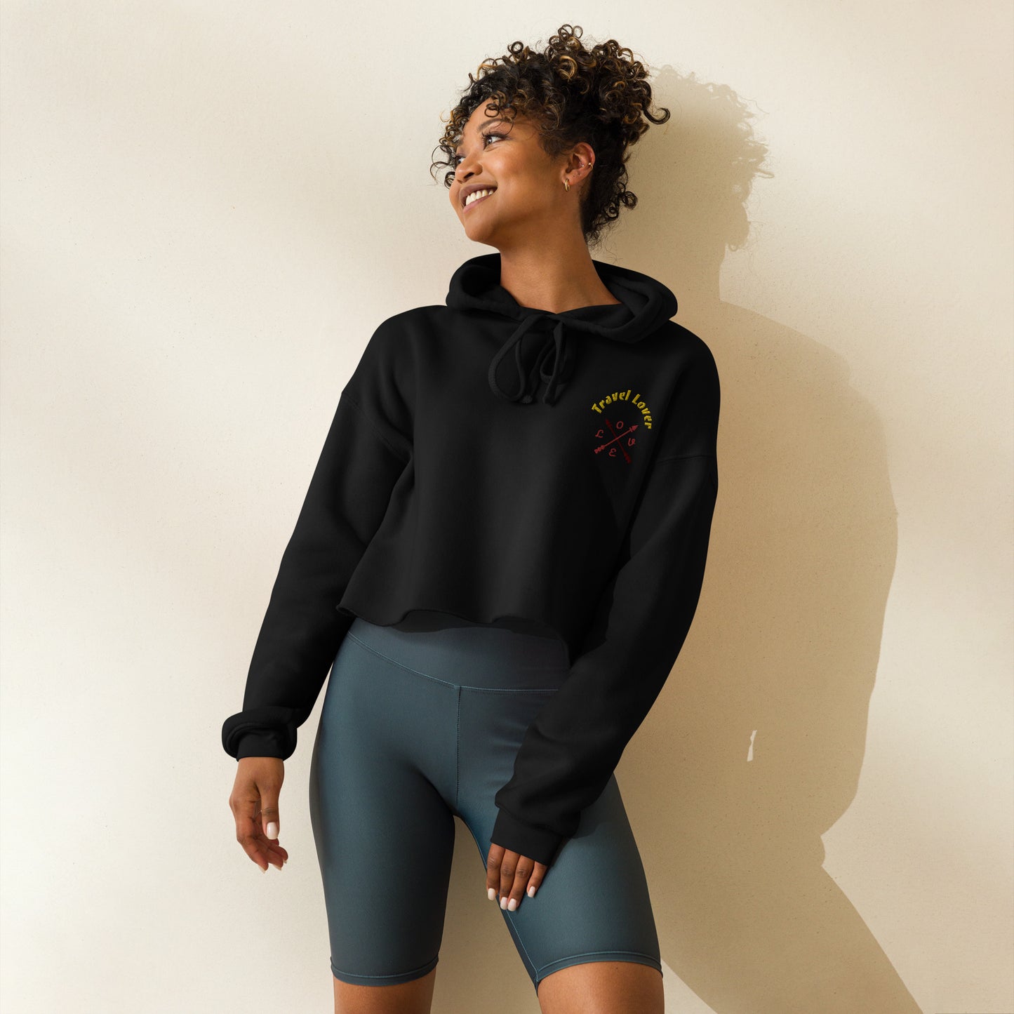 Travel Lover Crop Hoodie featuring raw hem and matching drawstrings, in stylish urban design military black front woman smile